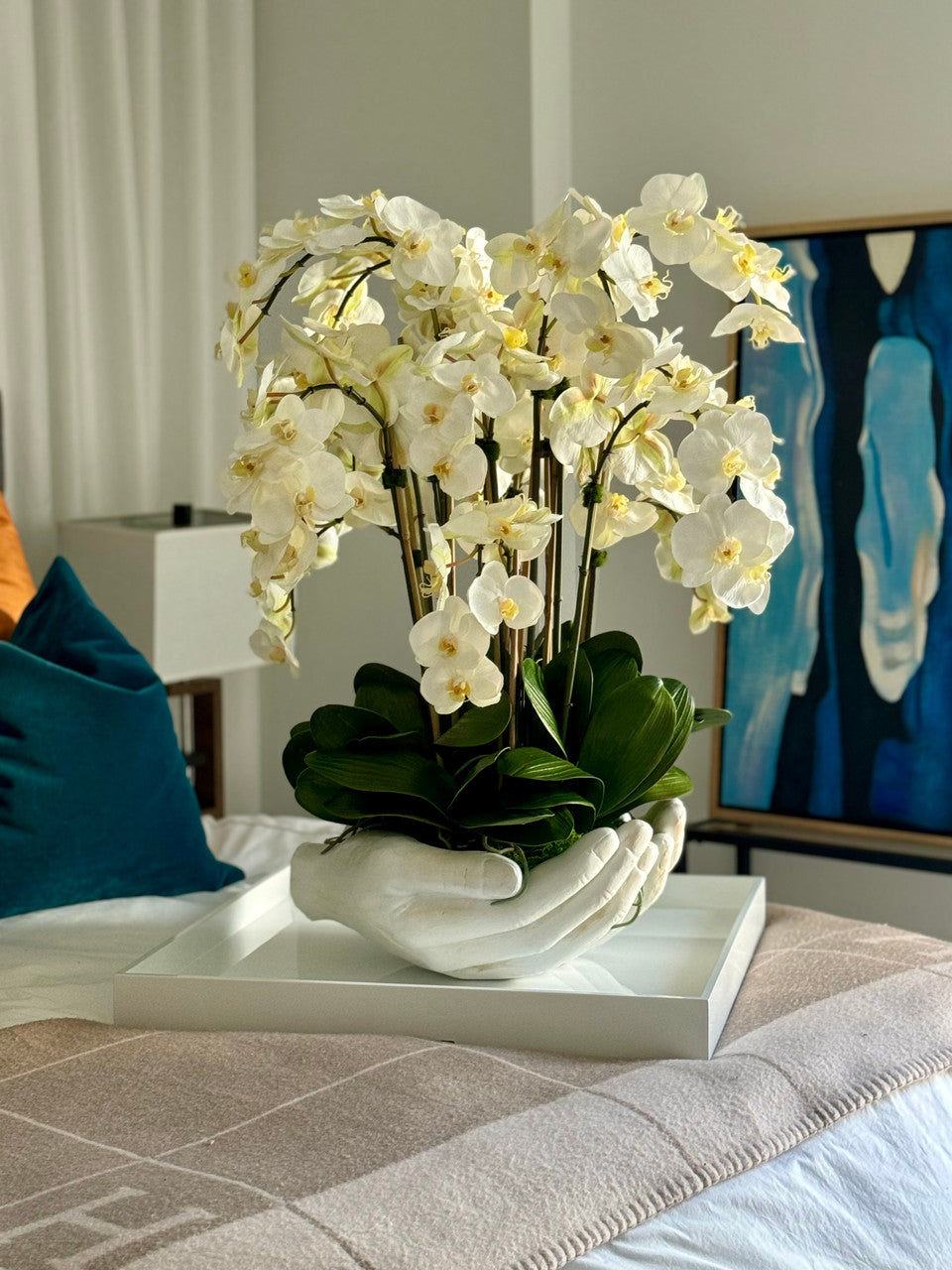 White Phalaenopsis Orchids in White Open Hands Sculpture Vase
