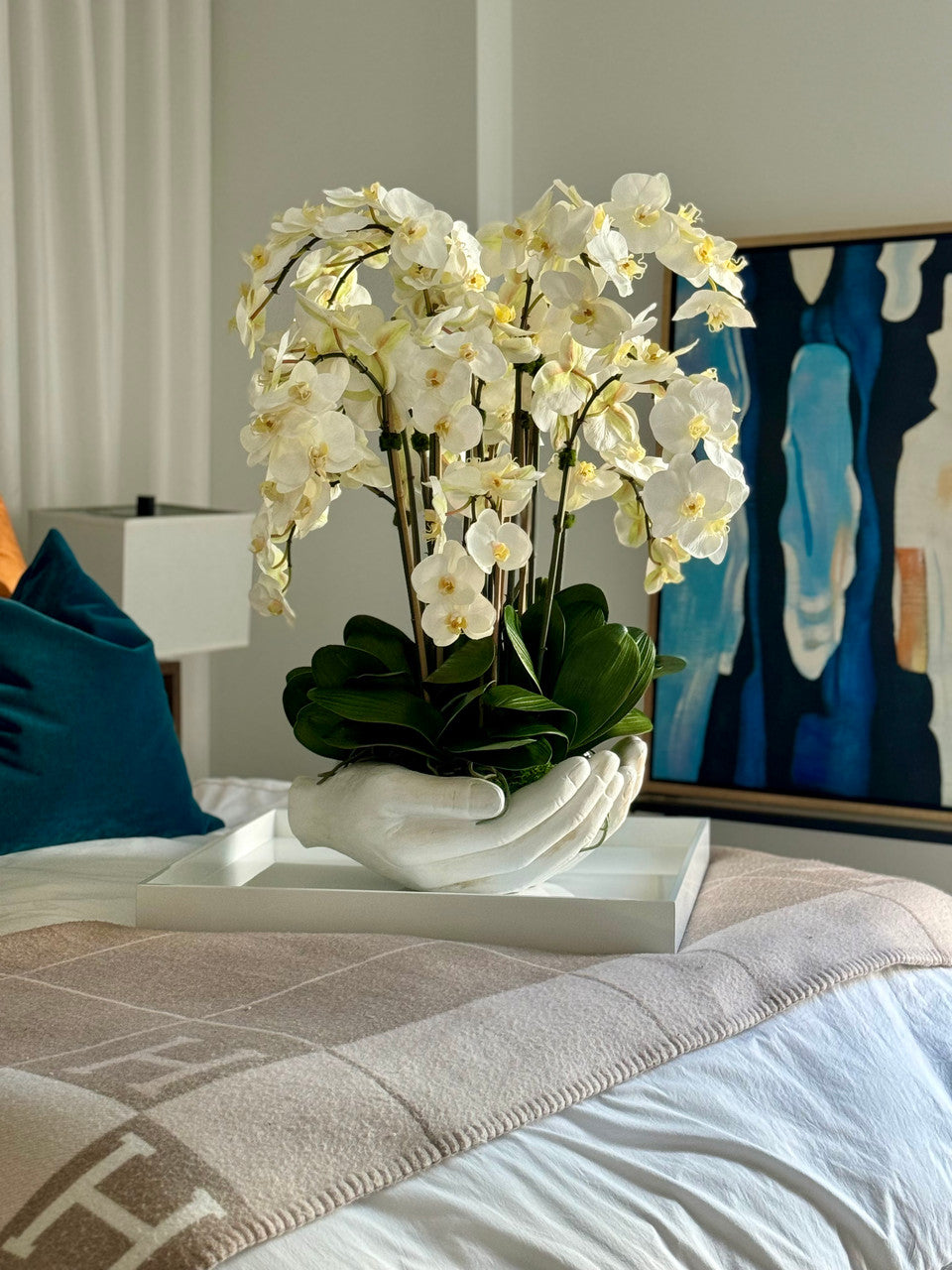 White Phalaenopsis Orchids in White Open Hands Sculpture Vase