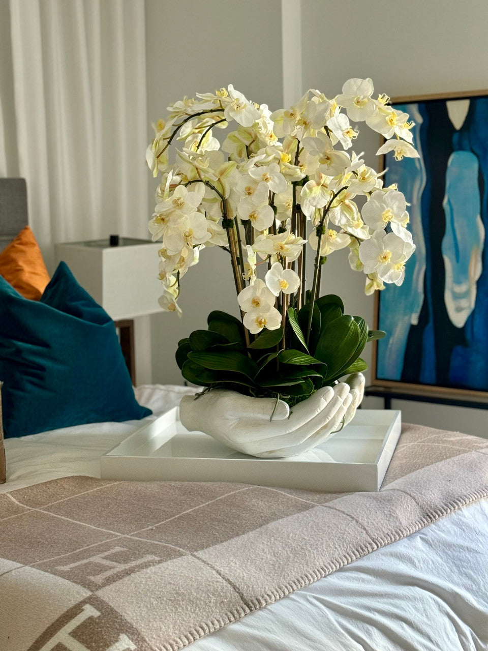 White Phalaenopsis Orchids in White Open Hands Sculpture Vase