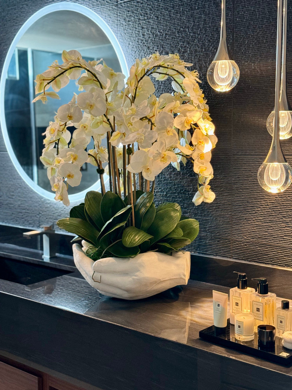 White Phalaenopsis Orchids in White Open Hands Sculpture Vase
