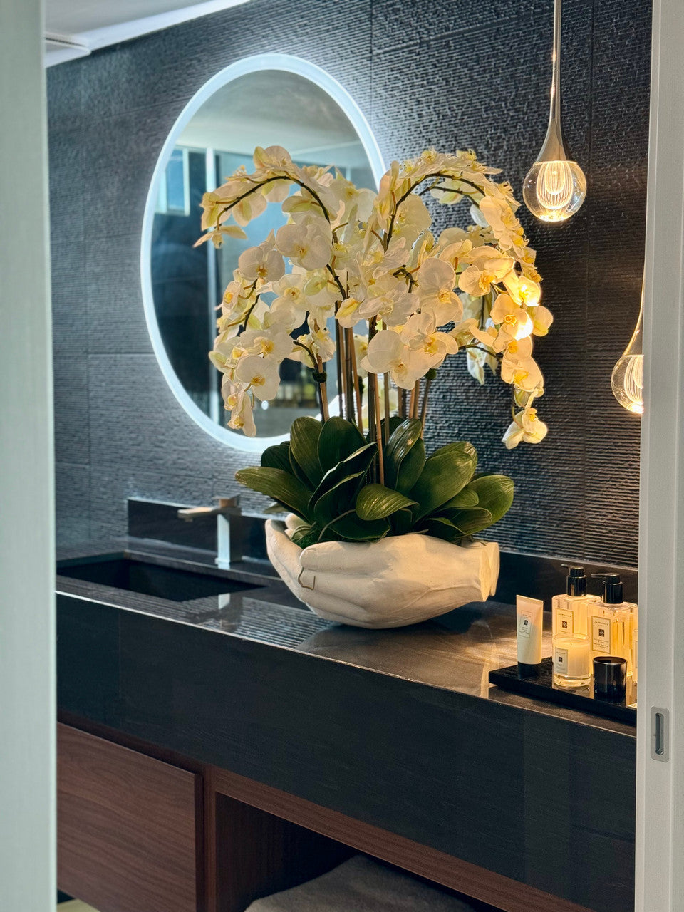 White Phalaenopsis Orchids in White Open Hands Sculpture Vase